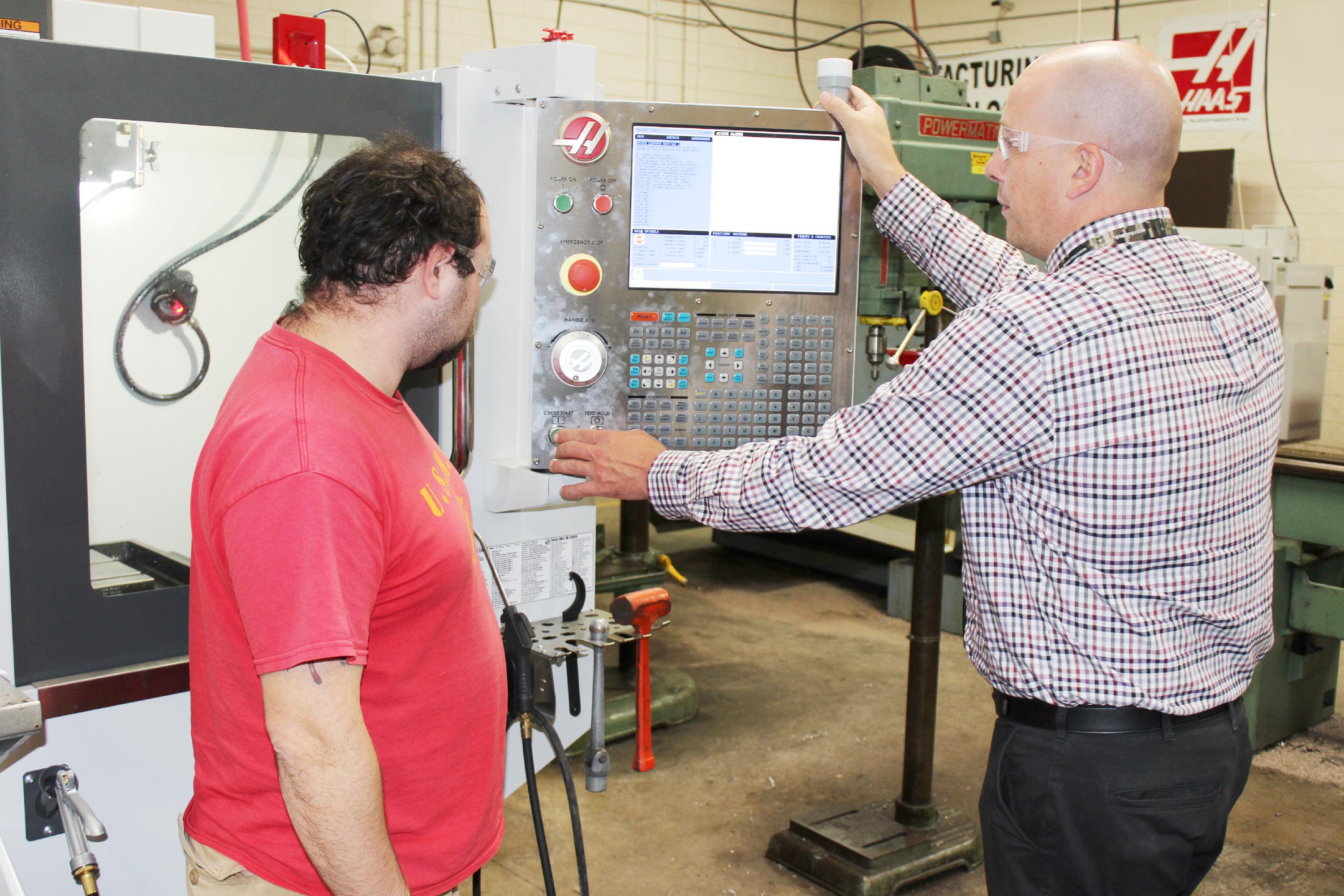 Instructor showing student how to use machine