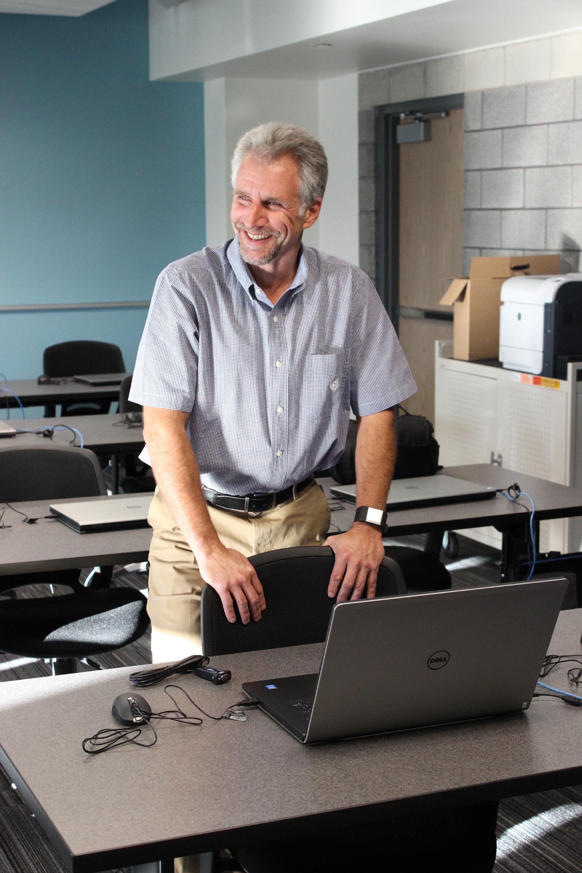 Steve Lewis smiles while looking off to the side