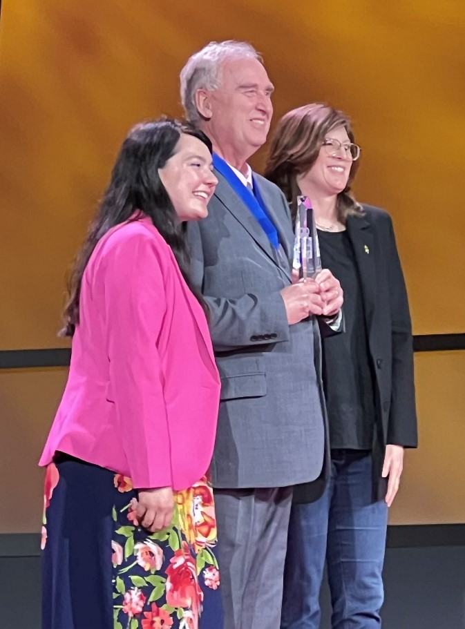 Dr. MacMaster stands on stage to receive his PTK award