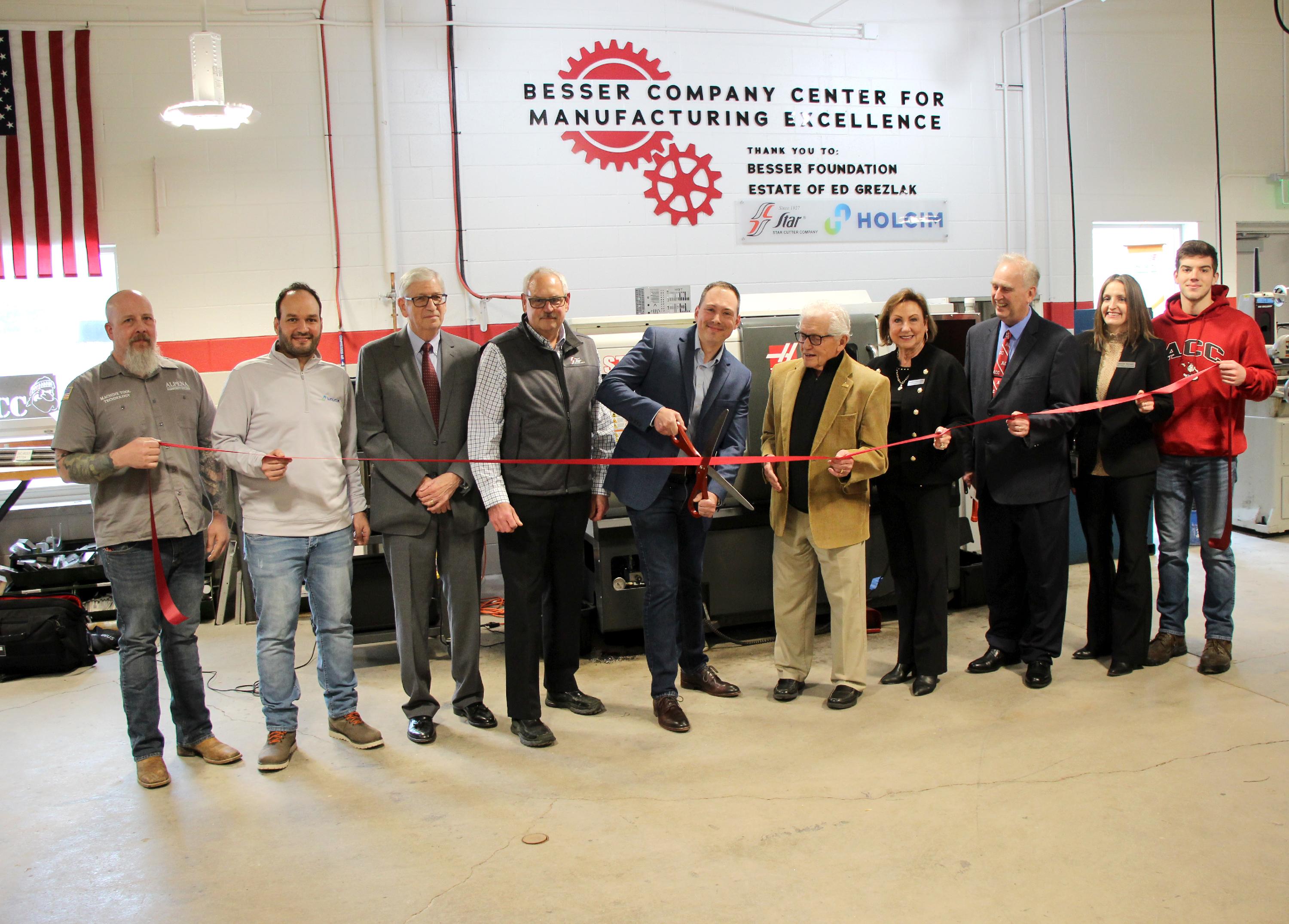 A group of people cut the ribbon at the new manufacturing lab
