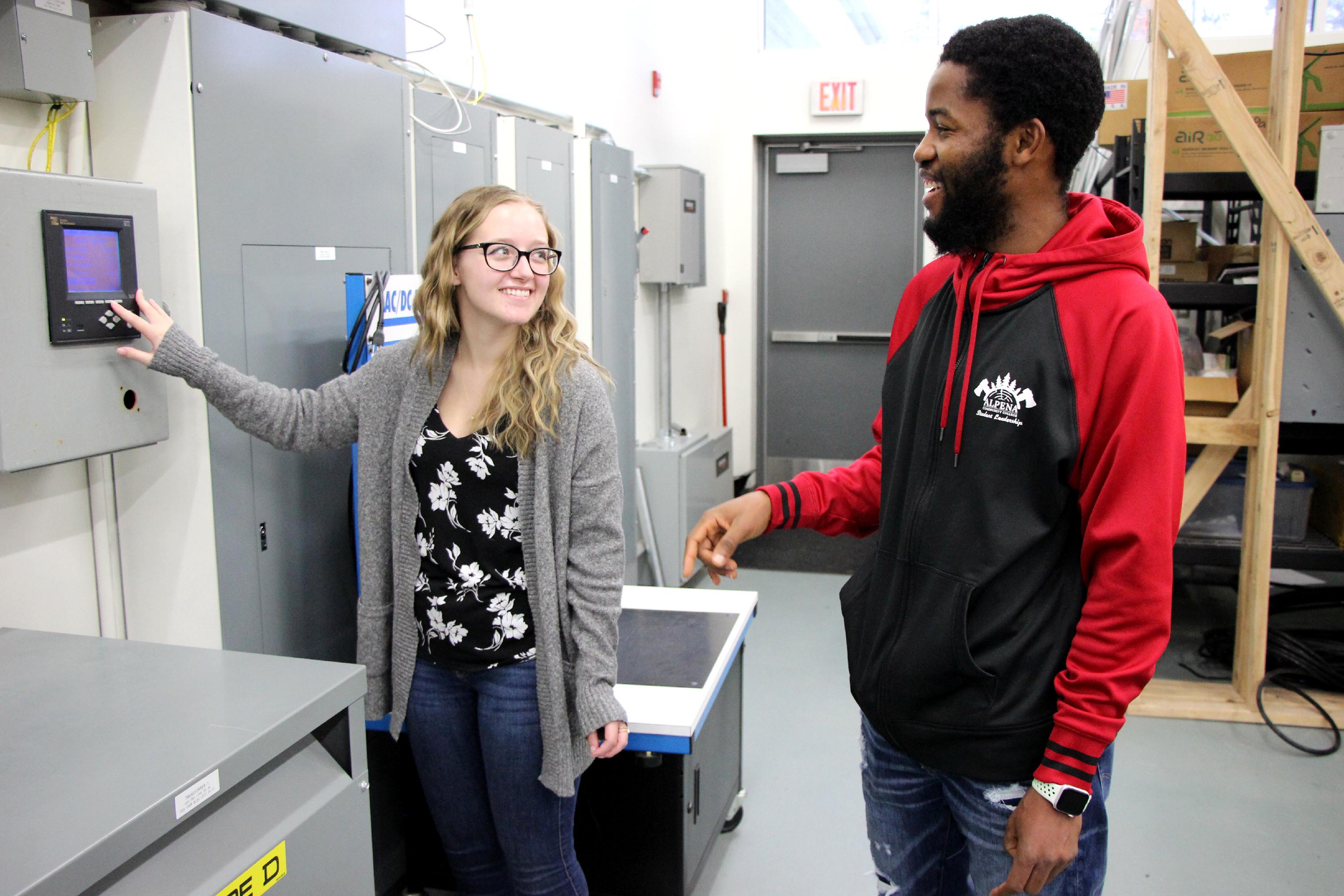 Adrianna and Musa examine an electrical panel